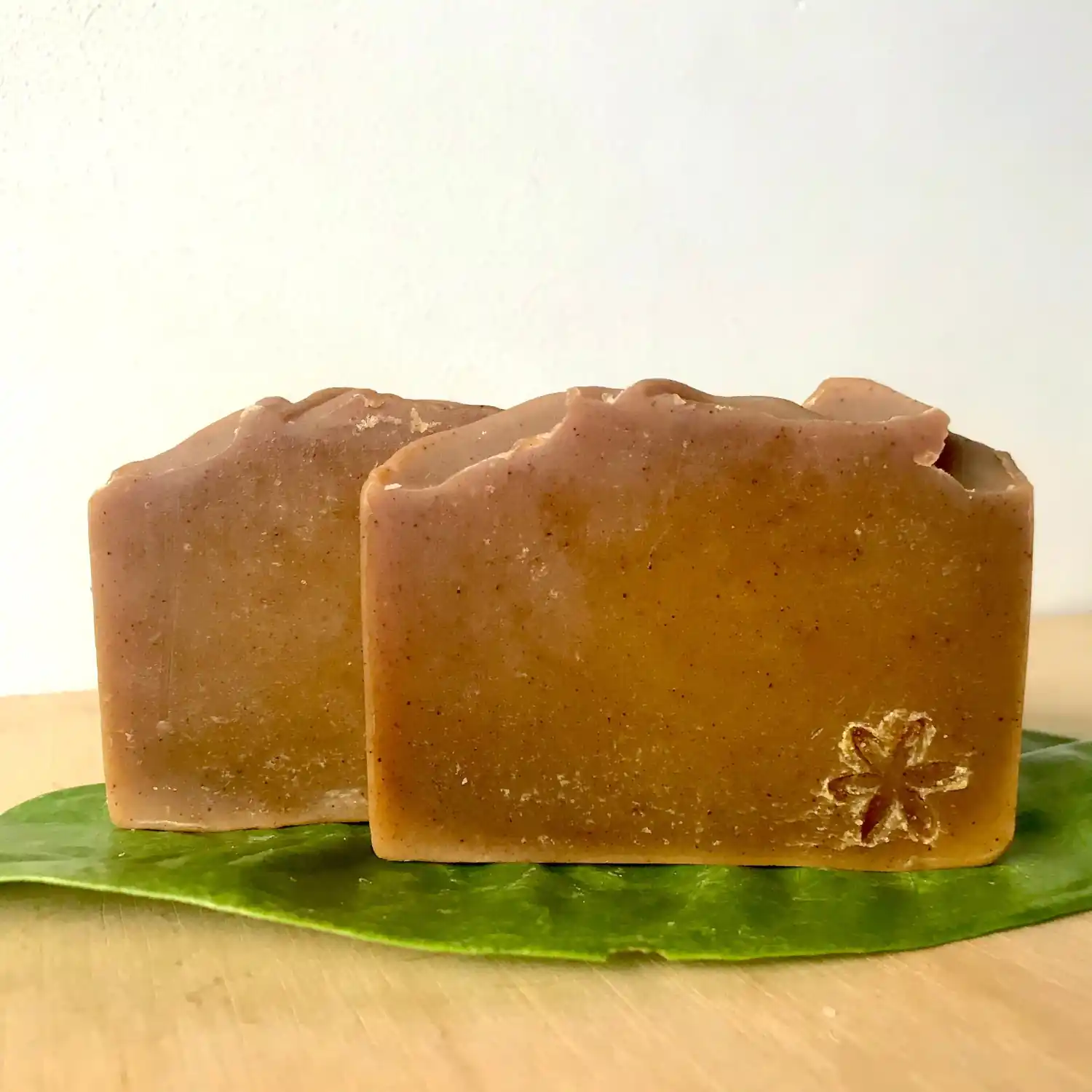two bars of brownish orange coloured soaps
